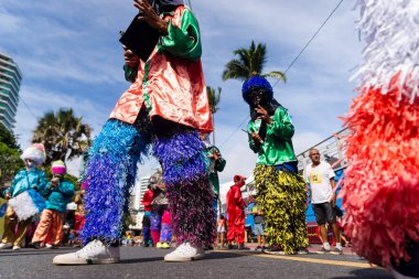 Salvador, Bahia, Brazil - February 11, 2023: Traditional masqueraders make a presentation playing percussion instruments during the Fuzue parade in Salvador, Bahia.