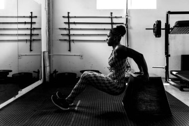 Spor salonunda kol egzersizi yapan kararlı bir kadın. Vücut güçlendirme.