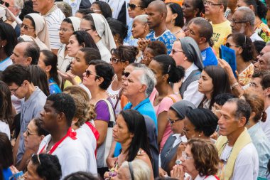 Salvador, Bahia, Brazil - May 26, 2016: Dozens of Catholic faithful are seen at the outdoor mass in honor of Corpus Christi in Salvador, Bahia.