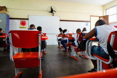 Salvador, Bahia, Brazil - September 20, 2022: Students at a public school, from the back, taking an exam on their return to school in Salvador, Bahia.