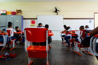 Salvador, Bahia, Brazil - September 20, 2022: Students at a public school, from the back, taking an exam on their return to school in Salvador, Bahia.