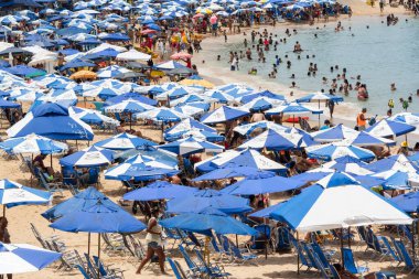 Salvador, Bahia, Brezilya - 14 Ocak 2022: Porto da Barra sahilinde kalabalık güçlü yaz güneşi altında eğleniyor. Salvador, Bahia.