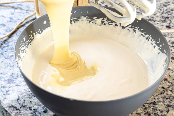 stock image Creamy ingredient being poured into the cheesecake pan. Family gastronomy.