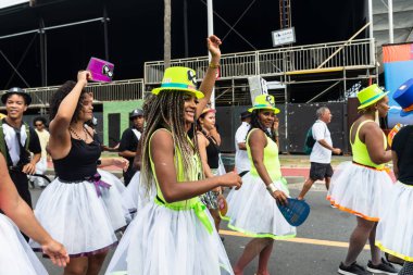 Salvador, Bahia, Brazil - February 11, 2023: Cultural group of women joyfully parade in the pre-carnival Fuzue, in Salvador, Bahia.