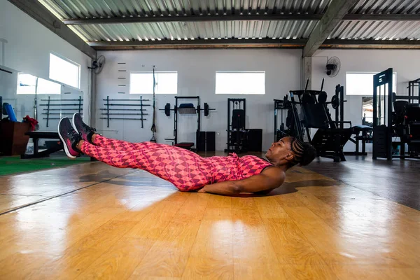 Woman training in modern studio. Doing exercise for the abdomen. laying on the floor.