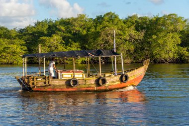 Valenca, Bahia, Brazil - September 09, 2022: Boat sailing on the Una river in the late afternoon in the city of Valenca, Bahia.