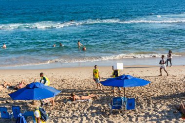 Salvador, Bahia, Brezilya - 22 Ekim 2022: Praia do Farol da Barra 'da sıcak bir günde dinlenen insanlar. Salvador, Bahia.