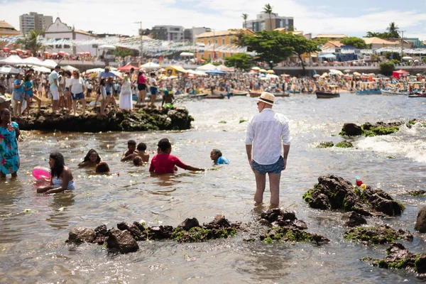 Salvador, Bahia, Brazil - February 02, 2023: Many people are on the beach of Rio Vermelho, offering gifts for the Yemanja party, in Salvador, Bahia.