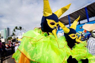 Salvador, Bahia, Brazil - February 11, 2023: A group wearing traditional Venetian carnival costumes are seen during the pre-Carnival Fuzue parade in the city of Salvador, Bahia.