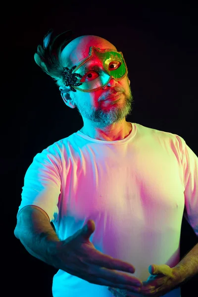 stock image Man portrait, bald, wearing carnival mask, looking at the camera. Isolated in the black background.