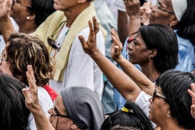 Salvador, Bahia, Brazil - May 26, 2016: Dozens of Catholic faithful are seen at the outdoor mass in honor of Corpus Christi in Salvador, Bahia.
