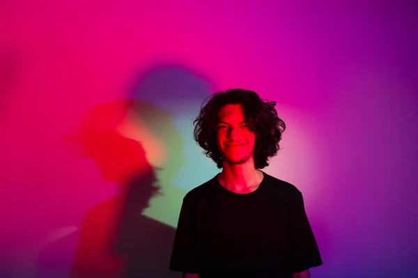 stock image Portrait of young handsome man with colorful shadows on photographic background. rgb colors