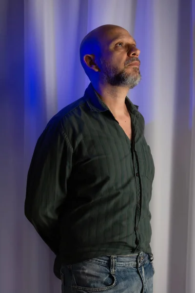 stock image Studio portrait of a man looking up. white curtain background