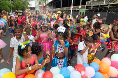 Salvador, Bahia, Brazil - February 11, 2023: Group of children are seen in the Fuzue carnival parade, in Salvador, Bahia.