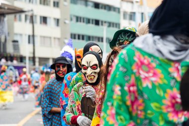 Salvador, Bahia, Brazil - February 11, 2023: People dressed in horror masks parade at the Fuzue carnival. City of Salvador, in Bahia.