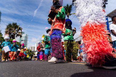 Salvador, Bahia, Brazil - February 11, 2023: Traditional masqueraders make a presentation playing percussion instruments during the Fuzue parade in Salvador, Bahia.