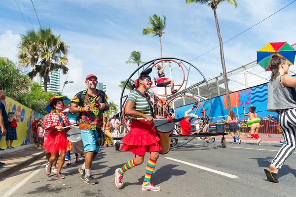 Salvador, Bahia, Brazil - February 11, 2023: Circus performers dance, sing and play percussion instruments during the pre-Carnival Fuzue parade in the city of Salvador, Bahia.