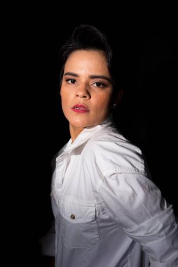 Vertical portrait of beautiful woman wearing white outfit. Isolated on black background.