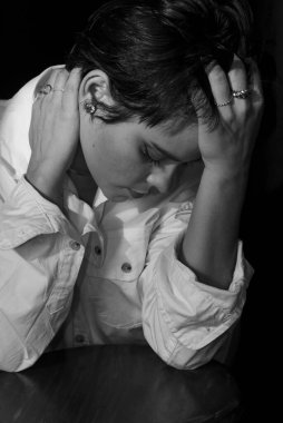Black and white portrait of beautiful woman wearing white outfit. Isolated on black background.