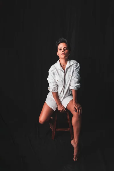Beautiful Young Woman Sitting Confident Wearing White Outfit Isolated Black — 스톡 사진