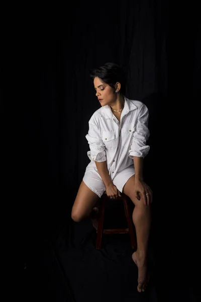 Beautiful Young Woman Sitting Confident Wearing White Outfit Isolated Black — Photo