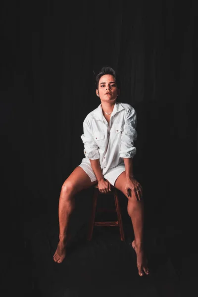 Beautiful Young Woman Sitting Confident Wearing White Outfit Isolated Black — Fotografia de Stock