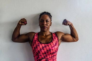 Beautiful woman showing upper muscles. isolated on white background.