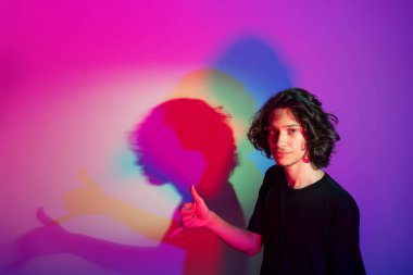 Fotografik arka planda renkli gölgeleri olan genç yakışıklı bir adamın portresi. rgb renkleri