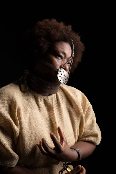 stock image Portrait of a black woman wearing an iron mask on her face to represent the pain of the slave Anastacia. Slavery in Brazil.