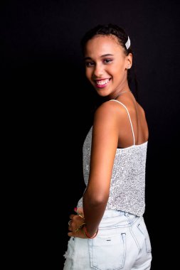 Genç bir kızın portresi, gülümseyen, güzel, beyaz elbiseler giyen. Siyah arkaplanda izole.