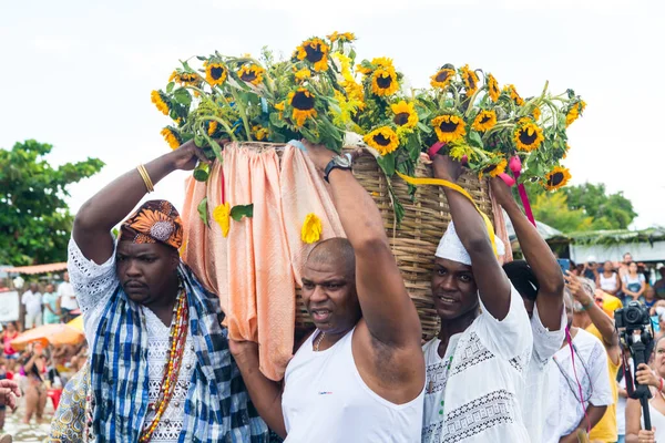 stock image Santo Amaro, Bahia, Brazil - May 15, 2022: Candomble members are carrying offerings to Yemanja during the Bembe do Mercado celebrations. Itapema Beach, Santo Amaro.