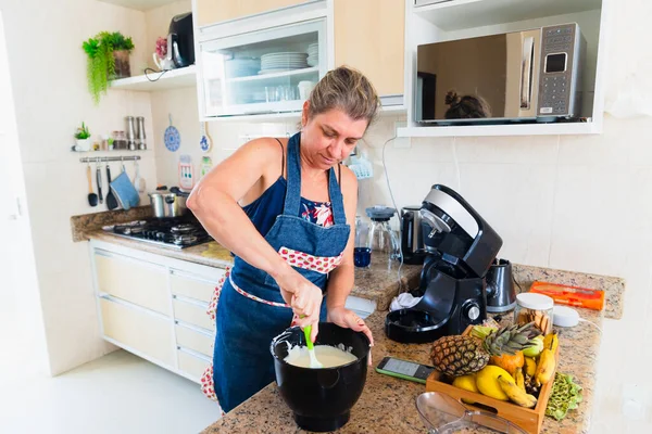 stock image Healthy food at home. Happy woman is preparing proper meal in the kitchen.