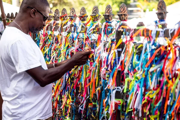 Salvador, Bahia, Brezilya - 06 Ocak 2023: Tapanlar, Salvador, Bahia 'daki Sinyor do Bonfim kilisesinin korkuluğuna renkli kurdeleler bağlıyorlar..