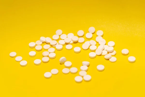 Mehrere Weiße Tabletten Auf Einer Gelben Oberfläche Medizinische Versorgung — Stockfoto