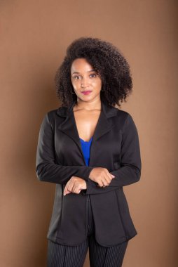 Genç iş kadını, zarif ve kendinden emin. Kahverengi arkaplanda izole.