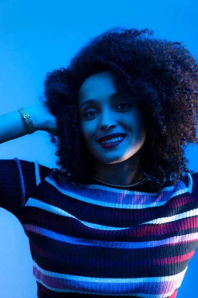 stock image Close-up portrait of beautiful young woman making hand gestures. Isolated on blue background.