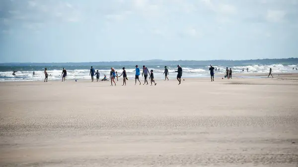 stock image Valenca, Bahia, Brazil - January 13, 2023: People walking and having fun at Guaibim beach in Valenca, Bahia.