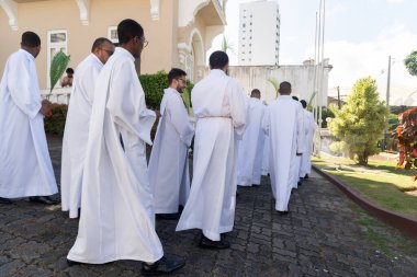 Salvador, Bahia, Brazil - April 02, 2023: Catholic seminarians walk to the site of the Palm Sunday open air mass in the city of Salvador, Bahia.
