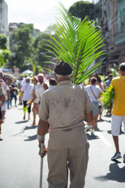 Salvador, Bahia, Brazil - April 02, 2023: Catholic church faithful are participating in the Palm Sunday procession in the city of Salvador, Bahia.