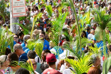 Salvador, Bahia, Brazil - April 02, 2023: Many faithful Catholics participate in the open-air Mass on Palm Sunday in the city of Savador, Bahia.