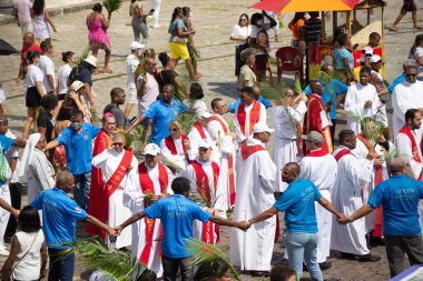Salvador, Bahia, Brazil - April 02, 2023: Catholic priests and faithful are seen during the Palm Sunday procession in the city of Salvador, Bahia.