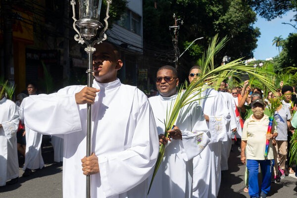 Salvador, Bahia, Brazil - April 02, 2023: Catholic priests and faithful are seen during the Palm Sunday procession in the city of Salvador, Bahia.