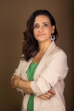 Gülümseyen ve kendine güvenen bir koçun portresi. Motivasyon ve demokratik yönetim. Kahverengi arkaplanda izole.