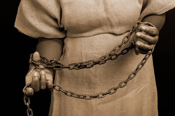 Portrait of a black woman in chains with an iron mask on her face representing the slave Anastacia. Old and rusty chains. Slavery in Brazil.