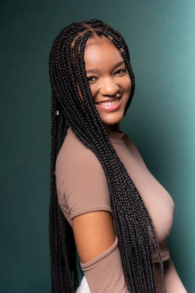 stock image Portrait of young, beautiful black model with long braided hair. Isolated on dark cyan background.