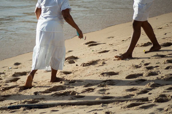 stock image Salvador, Bahia, Brazil - December 12, 2021: Candomble members are seen walking on the sands of Rio Vermelho beach in the city of Salvador, Bahia.