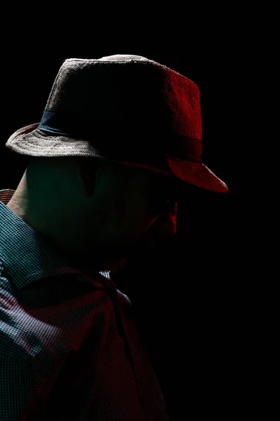 Stock image Mysterious man wearing hat and sunglasses. Portrait in dark studio.