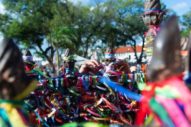 Salvador, Bahia, Brazil - December 29, 2023: People are seen paying homage to Senhor do Bonfim by tying a souvenir ribbon on the church's iron railing. City of Salvador, Bahia.