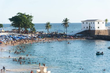 Salvador, Bahia, Brazil - October 21, 2023: View of Porto da Barra beach full of people bathing in the sun and sea in the city of Salvador, Bahia.