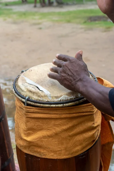 Hands of a percussionist playing atabaque at a religious event. Candomble celebration.
